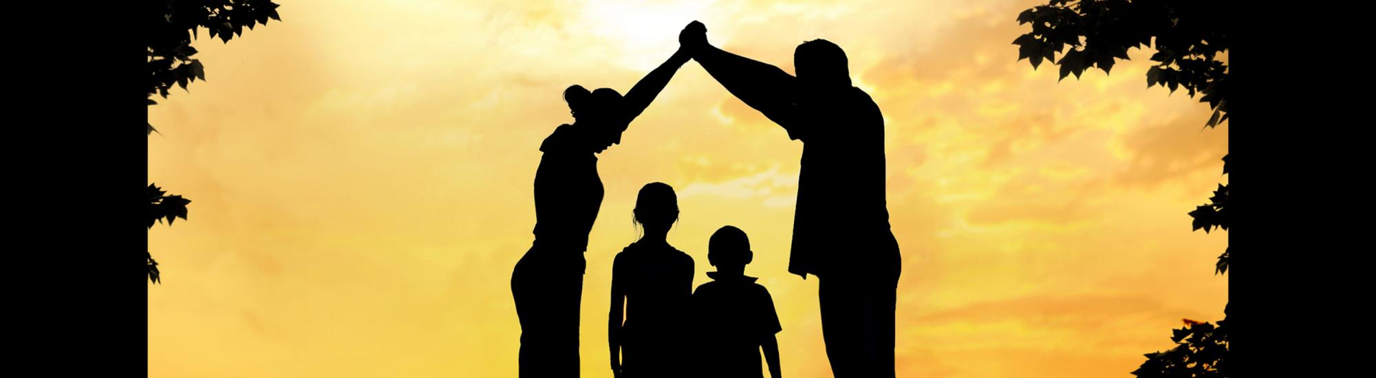 Family with parents arms over two children